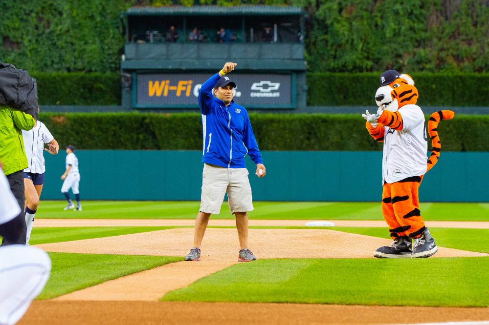 Tigers mascot cheering for man who just threw a pitch to a Tigers player